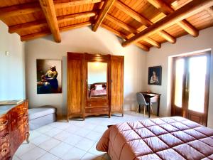 1 dormitorio con cama y techo de madera en Casa Vistabella, en Frassinello Olivola
