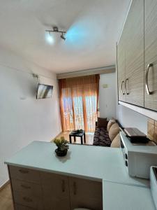 a kitchen with a counter top and a living room at Maroulitsas Sea Esta 2 in Haraki
