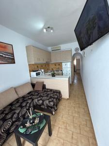 a living room with a couch and a kitchen at Maroulitsas Sea Esta 2 in Haraki