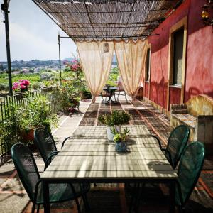 a table and chairs on a patio with a view at Saja Country House in Acireale