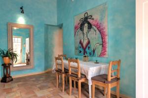 a dining room with a table and chairs and a mirror at Lotus apartment in Szentendre +21 photos