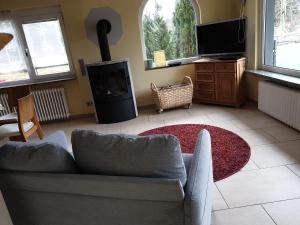 a living room with a couch and a fireplace at FEWO zum gscheiten Beck mit grosser Terrasse in Feldberg
