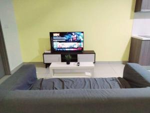Il comprend un salon doté d'un canapé et d'une télévision à écran plat. dans l'établissement HB2103- Cyberjaya- WiFi- Netflix-Parking, 3046, à Cyberjaya