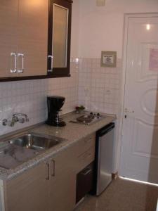 a kitchen with a sink and a counter top at Yianna Apartments in Faliraki