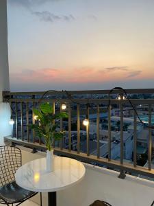 a balcony with a table and a view of a city at Alpha Homestay Marina Long Xuyên in Ấp Ðông An (1)