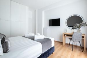 a bedroom with a bed and a desk with a mirror at Acropolis Exclusive Apartment in Athens