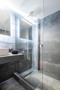 a bathroom with a shower and a sink at Acropolis Exclusive Apartment in Athens