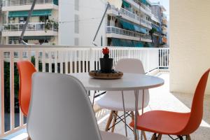 a table and chairs on a balcony with a table at Acropolis Exclusive Apartment in Athens