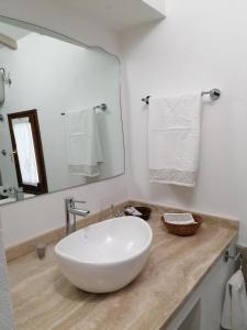 a bathroom with a white sink and a mirror at Il nido dei Priori in Volterra