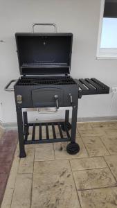 a barbecue grill sitting on top of a floor at AGGELOS GARDEN VIEW in Faliraki +20 photos