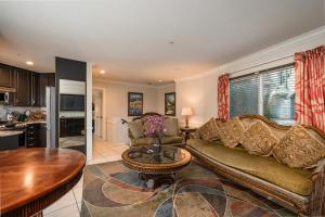 a living room with a couch and a table at Casa Mariquita Hotel by Omeo in Avalon