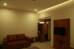 a living room with a couch and a television at Casa Orchid in Alleppey