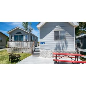 a house with a picnic table and a bench at Snug Harbor RV Park & Marina in Walnut Grove