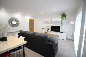 a living room with a couch and a table at Nice new apartment only 30min to Barcelona center. in Granollers