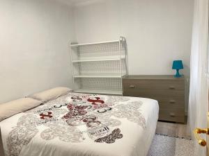 a bedroom with a bed with a bedspread with hearts on it at Nice new apartment only 30min to Barcelona center. in Granollers
