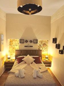 a bedroom with a large bed with two towels on it at Harmony 2 in Gold in Lávrion