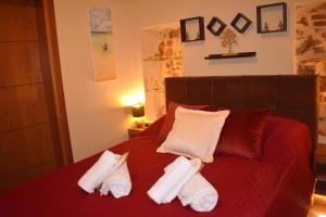a bedroom with a bed with towels on it at Harmony 2 in Gold in Lávrion