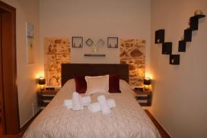 a bedroom with a bed with two pillows at Harmony 2 in Gold in Lavrio