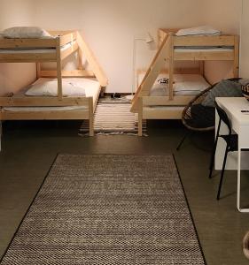 a room with two bunk beds and a rug at Vandrarhemmet Eken in Eksjö