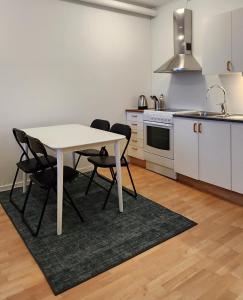 a kitchen with a table and chairs in a room at Vandrarhemmet Eken in Eksjö
