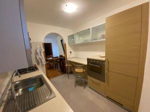 a kitchen with a sink and a counter top at Appartamento Alessio in Ledro
