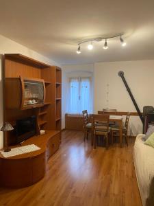 a living room with a table and a dining room at Appartamento Alessio in Ledro