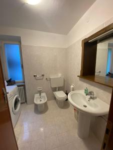 a bathroom with a toilet and a sink at Appartamento Alessio in Ledro