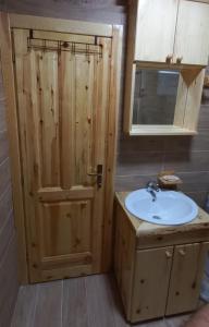 a bathroom with a sink and a wooden cabinet at Chalet Čilac in Žabljak