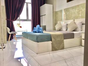 Postel nebo postele na pokoji v ubytování SaiGon CoZy Hotel "241 Pham Ngu Lao Street''