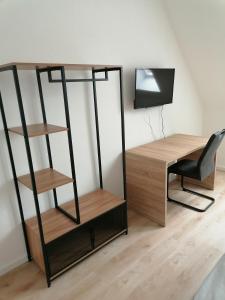 escritorio y silla en una habitación con escritorio y estante en Altes Gesellenhaus en Dinklage