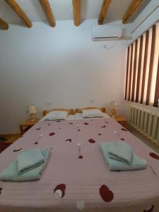 a bedroom with a large bed with red hearts on it at KHIVA ABDULLA Guest House in Khiva