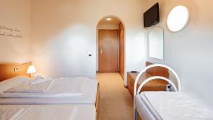 Ένα ή περισσότερα κρεβάτια σε δωμάτιο στο Hotel Corno Bianco
