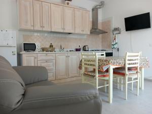 a kitchen with a couch and a table and chairs at Da Raff in Lacco Ameno