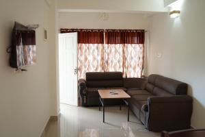 a living room with a couch and a table at Caravan holiday homes Vythiri in Vythiri
