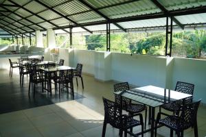 a group of tables and chairs in a restaurant at Caravan holiday homes Vythiri in Vythiri