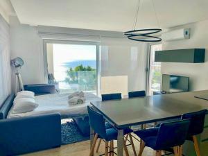 a room with a bed and a table and chairs at Mont des Olives - Cap D'ail- app4 in Saint-Antoine