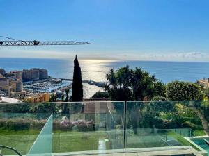 a view of the ocean from the balcony of a house at Mont des Olives - Cap D'ail- app4 in Saint-Antoine
