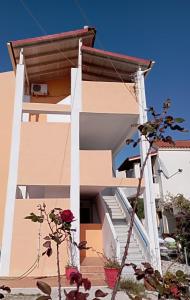 een gebouw met trappen en bloemen ervoor bij Agapi Studio Acharavi à 50m de la mer, 400m du centre ville in Acharavi