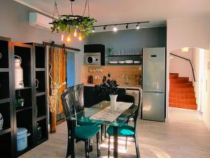 a dining room and kitchen with a table and chairs at Villa Neptuno in Tossa de Mar