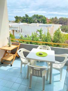 a white table and chairs on a balcony at Residenza Tigli Campomarino Lido in Campomarino