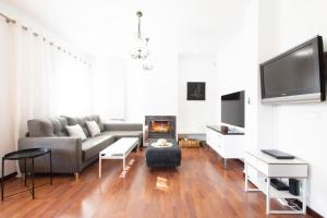 a living room with a couch and a tv at Villa Nelly in Alcudia