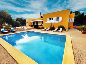 a swimming pool in front of a house at Bonita Casa con piscina privada y amplio jardin in Sant Francesc de s'Estany