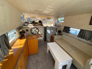 a view of a kitchen and a living room in an rv at - DIVALI - Duerme en un Confortable Yate en Barcelona in Barcelona