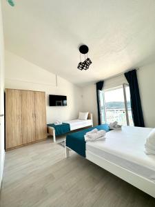 a bedroom with two beds and a window at Villa Senka in Neum