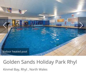 a large swimming pool with blue water in a gym at The Oakley golden sands rhyl in Kinmel Bay