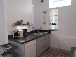 a kitchen with a sink and a counter top at La Maison de Léonie in Péronne