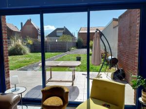 a view of a patio from the window of a house at La Maison de Léonie in Péronne
