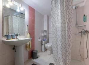 a bathroom with a sink and a toilet and a shower at Historical Old Town - Casa d'Irene in Kos