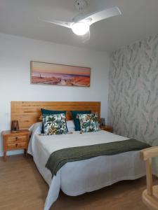a bedroom with a bed and a ceiling fan at Kailani Tacoronte in Santa Cruz de Tenerife