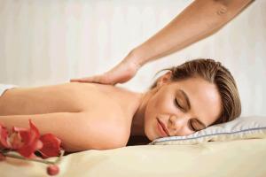a woman laying on a bed with her arm above her head at Villa Cipriano in Minturno